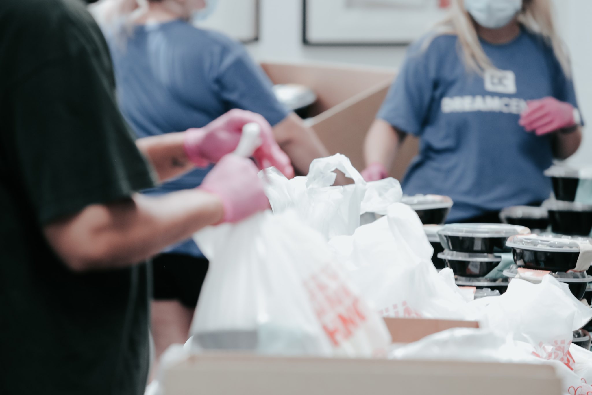 Pictures of volunteers packaging food